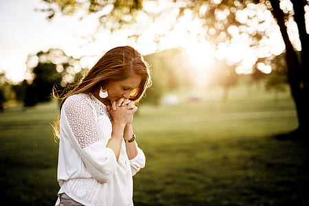 woman praying shallow focus thumbnail
