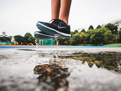reflection photography of a person wearing sneakers thumbnail