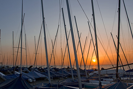 Wide-angle shot of boat masts at sunset on the coast of Whitstable in Kent, England thumbnail