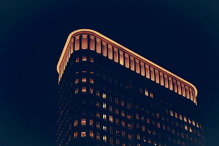 low angel photography of lighted building at night thumbnail