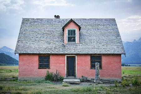 orange and gray house on green field thumbnail
