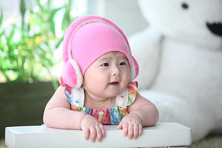 baby wearing pink earmuffs thumbnail