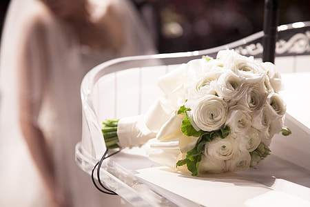 bouquet of white roses placed on clear glass shelf selective focal photo thumbnail
