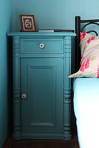 blue wooden cabinet beside black bed thumbnail