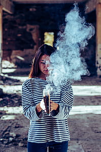 woman burning book during daytime thumbnail