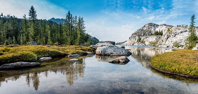 photo of calm body of water across mountain thumbnail