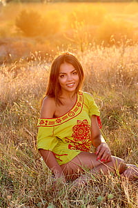 woman wearing yellow and red floral top surface green plant thumbnail