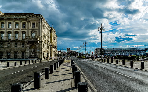 View of City Street Against Cloudy Sky thumbnail