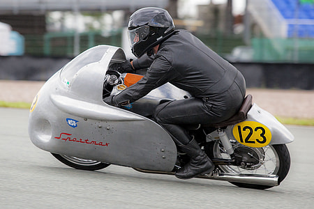man riding silver and black motorcycle thumbnail