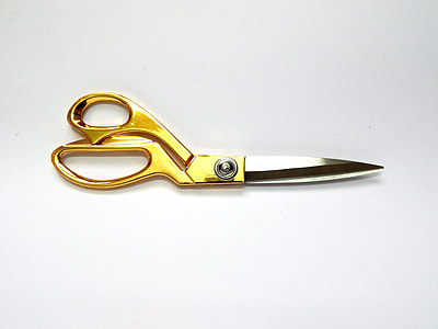 gold and silver shears on white surface thumbnail