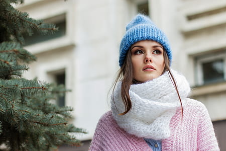 woman wearing white knitted scarf and pink cardigan thumbnail