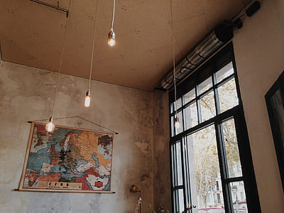 world map tapestry hanging on wall near glass doors thumbnail