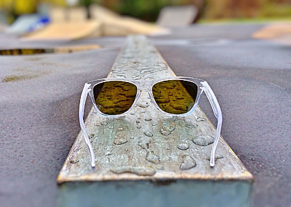 clear plastic framed sunglasses on brown wooden board thumbnail