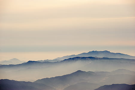 green mountains covered by mist at daytime thumbnail