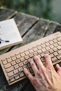 Male hand on the wooden keyboard thumbnail