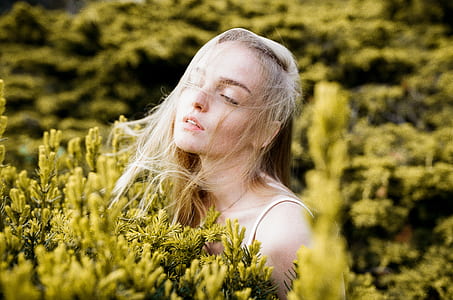 woman surrounded by green plants thumbnail