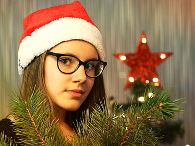 woman wearing Santa hat standing near red star finial thumbnail
