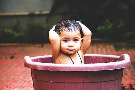 Baby bathing in bath thumbnail