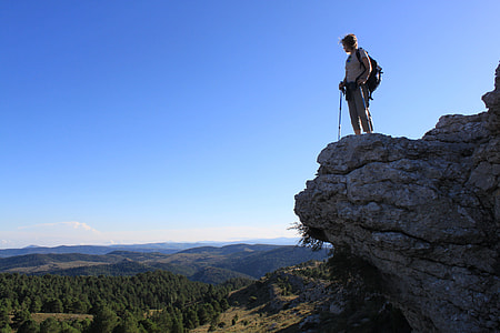man standing on top of mountain facing sideways thumbnail