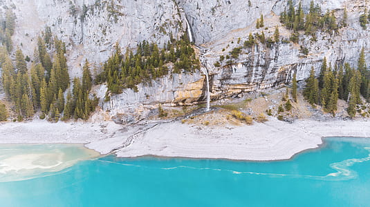body of water and trees near mountain thumbnail