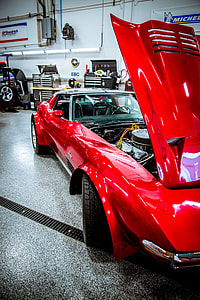red coupe on gray surface thumbnail