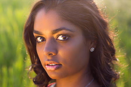 selective focus photography of woman wearing stud earrings looking straight thumbnail