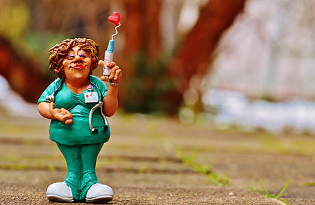selective photography of woman holding syringe figure thumbnail
