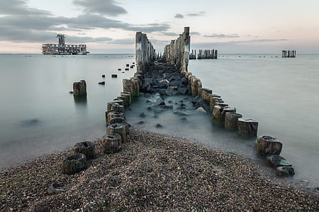 broken dock surrounded by body of water thumbnail