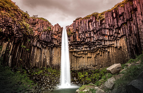 waterfalls between brown concrete mountain thumbnail