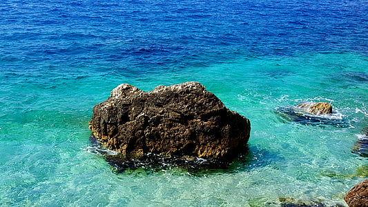 brown rock formation in body of water thumbnail