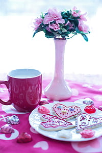 pink petaled flowers with white ceramic vase beside red ceramic mug thumbnail