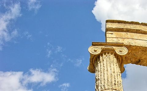 ionic column under cloudy sky thumbnail