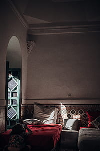 woman sitting in front of bed using smartphone thumbnail