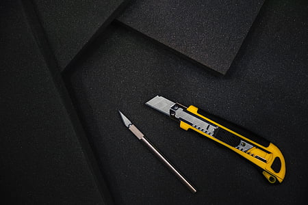 yellow utility knife on black mat thumbnail