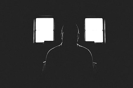 silhouette of man sitting near window thumbnail