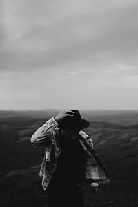 grayscale photo of man walking in a field thumbnail
