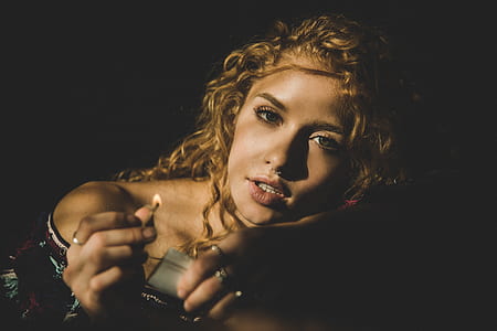 photography of woman holding safety match stick thumbnail