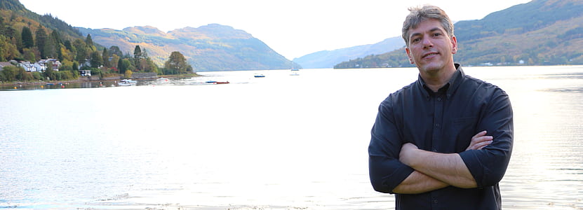 man standing beside body of water at daytime thumbnail