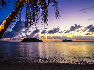 silhouette of island on ocean during golden hour thumbnail