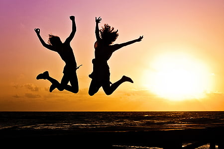 jump shot silhouette of two women during golden time thumbnail