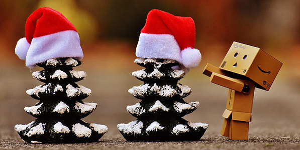 closeup photo of box figurine near the mini Christmas trees thumbnail