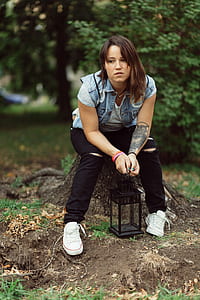 woman sitting on log on outdoors thumbnail