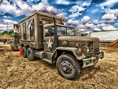 grey military truck on camp during daytime thumbnail