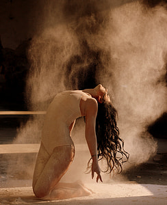 woman in white one-piece suit dancing thumbnail
