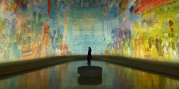 person standing on round stone with canvas wall painting thumbnail