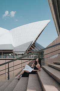 woman sitting on staircase near Sydney Opera House thumbnail