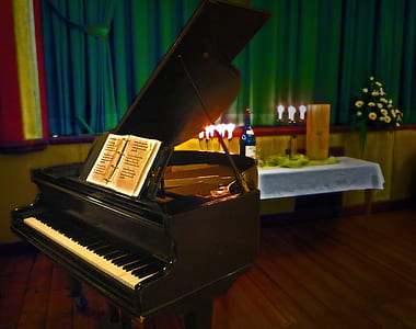 brown grand piano beside table near window thumbnail