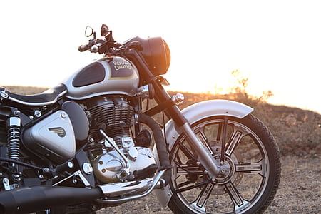 black and silver cruiser motorcycle parked on road thumbnail