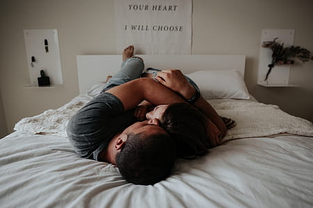 couple lying on bed while hugging thumbnail