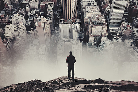 man standing overlook a city at daytime thumbnail